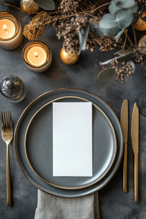 A beautifully arranged dinner table features gold utensils, plates, and decorative elements, creating a warm and inviting atmosphere for a winter gathering or holiday celebration.の素材