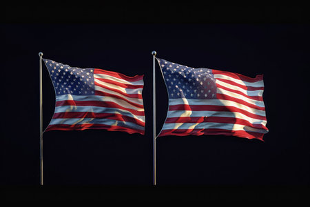 A close-up shot of two weathered American flags waving in the wind, set against a dark background.の素材
