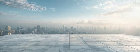 A wide shot of an empty rooftop overlooking a hazy city skyline under a cloudy blue sky.の素材