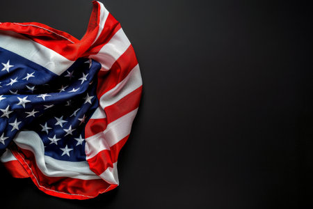 A close-up image of a folded American flag on a black background.の素材