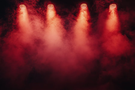 Bright red lights shine down from above, creating a dramatic atmosphere in a performance venue. The beams slice through a light mist, enhancing the energetic ambiance of the event.の素材