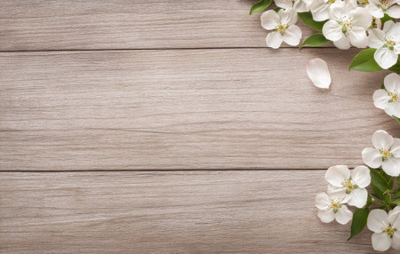 A heart shaped stone rests amidst blooming spring flowers, including white petals and pink buds, on a rustic wooden background, creating a serene and romantic atmosphere.の素材