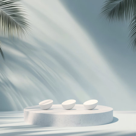 A minimalist display platform in white is set against a light blue background adorned with tropical leaves casting soft shadows. The atmosphere is calm and serene, ideal for showcasing products.の素材