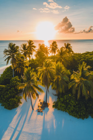 A serene tropical island features lush palm trees silhouetted by a stunning sunset. Soft waves lap against the white sandy beach, creating a peaceful atmosphere for relaxation.の素材