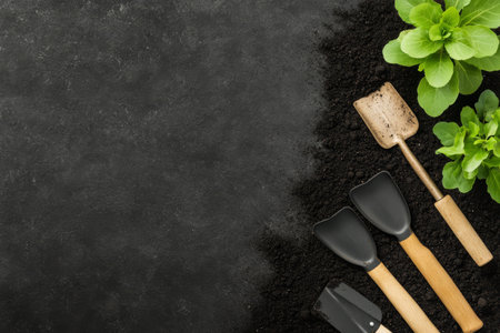 Small pots filled with soil hold fresh herb plants, alongside a wooden planting tool. The dark background enhances the vibrant greens of the herbs, creating a serene gardening atmosphere.の素材