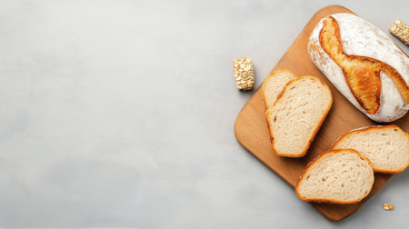 Delicious freshly baked bread loaves are arranged neatly on a wooden cutting board. Several slices are cut and displayed, highlighting the breads golden crust and soft interior.の素材