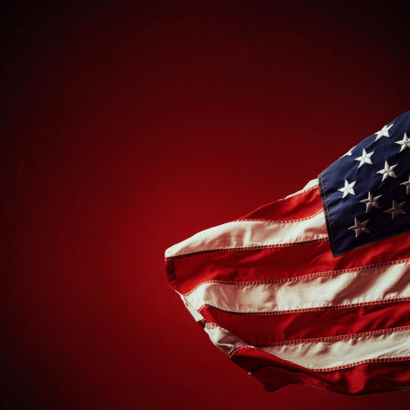 The American flag is displayed gracefully with its stars and stripes against a bright red backdrop, symbolizing national pride and unity during a celebratory event or holiday.の素材