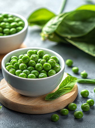 Two intertwined wedding rings rest on a smooth rustic plate surrounded by delicate green leaves and softly draped fabric, creating a serene and romantic atmosphere.の素材