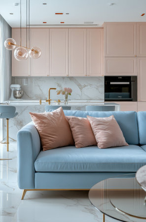 Bright and spacious living room features a light blue sofa with decorative pillows. Stylish hanging light fixtures and sleek cabinetry enhance the contemporary decor.の素材