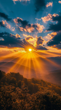 A breathtaking sunset casts golden rays over tranquil hills, with soft clouds adding depth to the sky. Wildflowers in the foreground enhance the serene natural beauty at dusk.の素材