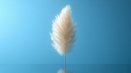Delicate pampas grass stands gracefully above the calm water, reflecting soft hues of light while surrounded by a peaceful backdrop, showing nature's beauty.の素材