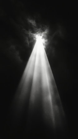 A striking beam of light pierces through complete darkness, revealing floating particles that create a mystical atmosphere. The scene captivates with its contrast and depth.の素材