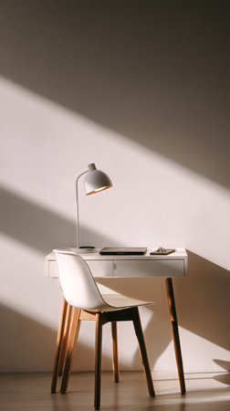 A serene workspace features a minimalist desk with a laptop, stationery, and a stylish lamp. Soft, warm light creates a calming atmosphere for productivity in the evening.の素材