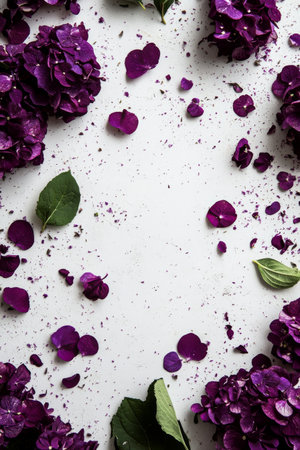 Purple hydrangea flowers border a white surface, with petals and leaves scattered around, creating a simple yet elegant floral display that evokes a sense of calm.の素材