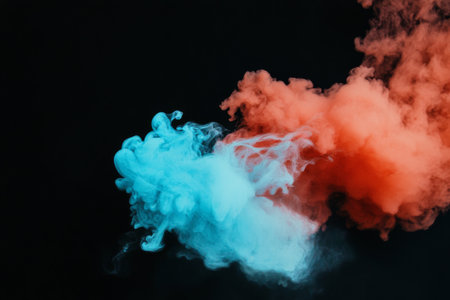 Vivid swirls of blue and red smoke blend, creating striking visual effects against a black background during a nighttime event, captivating viewers with their movement.の素材