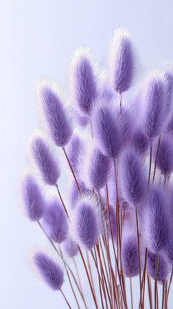 A bouquet of purple dried flowers stands elegantly against a light background. The soft, fluffy textures create a calming and aesthetic appeal, perfect for modern home decor.の素材