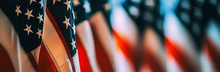 Several United States flags stand tall in a ceremonial hall, creating a respectful atmosphere for an official event. Soft lighting enhances the solemn mood within the space.の素材