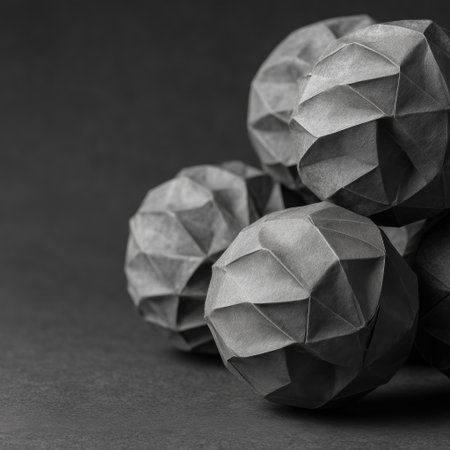 Polygonal black and white paper balls on a dark background.の素材