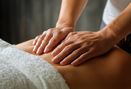 A skilled therapist provides a soothing massage on a clients back in a tranquil spa setting, promoting relaxation and muscle recovery.の素材