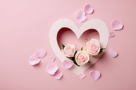 A heart-shaped cutout reveals soft pink roses surrounded by smaller pink hearts. This setting is perfect for romantic occasions and celebrations of love..の素材