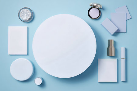 Various beauty items, including skincare and makeup containers, are neatly arranged on a light blue surface, showing a minimalist aesthetic perfect for beauty enthusiasts.の素材