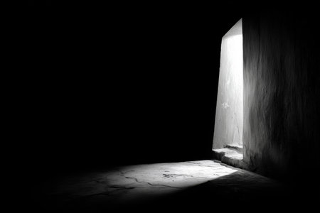 A view from within a dark tunnel shows a bright circular opening above. The contrast highlights the rough texture of the tunnel walls and the surrounding darkness. Details matter.の素材