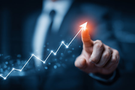 A person in a suit points toward a glowing arrow on a line graph indicating upward business growth during an evening setting.の素材