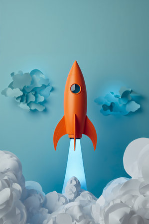 A bright orange rocket is lifting off, surrounded by fluffy clouds. The background features blue rays radiating outward, creating an exciting atmosphere of movement and adventure.の素材