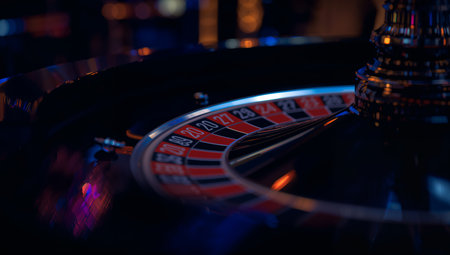 The roulette wheel spins in a casino. Players watch closely as small ball bounces around the numbers.の素材