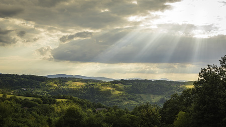 Mionica, Serbia - July 24, 2017: Landscape photo of hills of Mionica on a cloudy day with sun shining through clouds, Mionica, Serbiaのeditorial素材