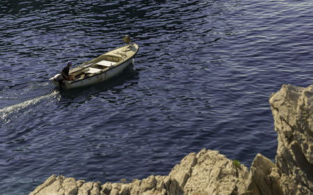Peljesac, Croatia - June 20, 2017: Fisherman goes fishing in a small boat early in the morning,...
