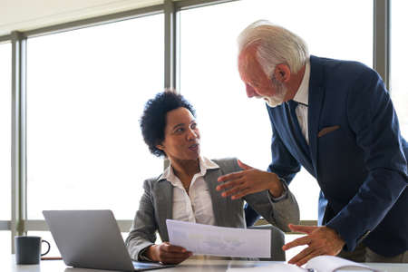 Multiracial business partners discussing project. Diverse managers analyzing work result thinking of...