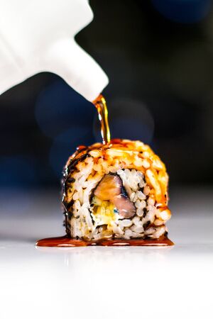 Sushi rolls pours soy sauceの写真素材