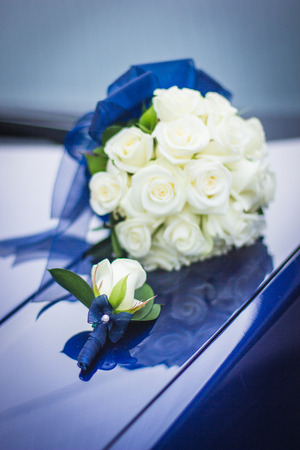 Wedding bouquet of white roses in bright colors with a blue handle.の写真素材