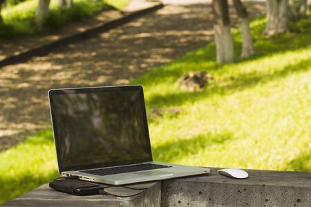 Laptop sunny summer day in the urban environment.の写真素材