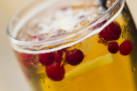 Cold lemonade with cranberries, ginger and ice on the outdoor veranda summer day, sunlight.の写真素材