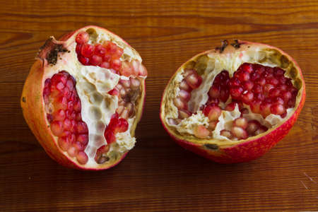 Pomegranate on a wooden background, studio lighting