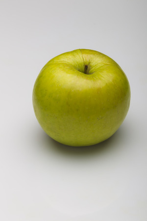 Green apple on a white background, studio lighting, the top viewの写真素材