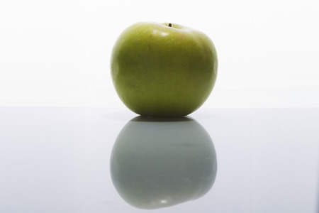 Green apple on a white background, studio lighting, the top viewの写真素材