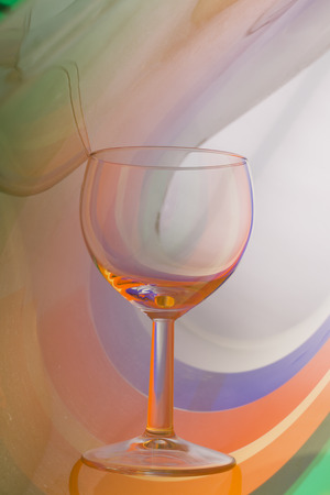 Wine glass on an abstract colored background, studio lightingの写真素材