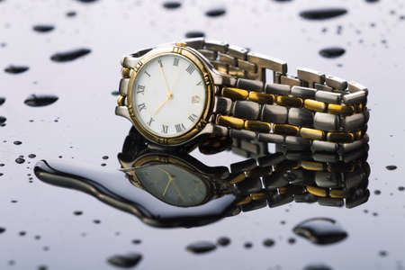 Watches with water drops on a white acrylic background, studio lightingの写真素材