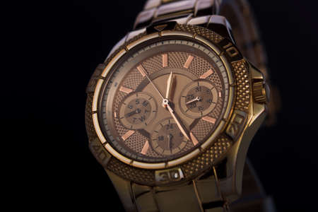 Gold watch on a monochrome plastic background, studio lighting, Macroの写真素材