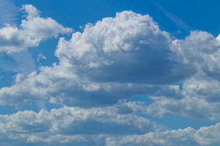White cumulus clouds against a blue sky, sunshineの写真素材
