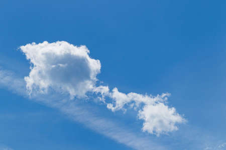 White cumulus clouds against a blue sky, sunshineの写真素材