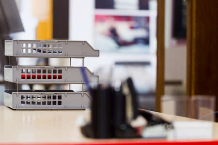 A set of office supplies on the background of office interior, mixed lightの写真素材