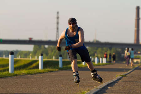 A man riding on roller skates in the city, lit by natural lightの写真素材