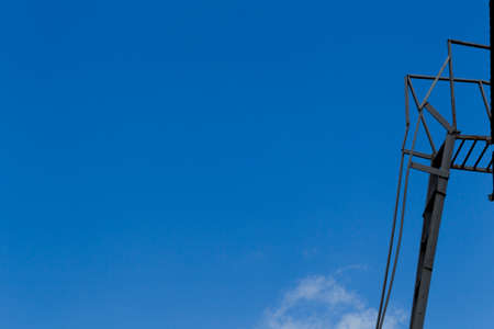 Ladder against the blue sky and white cloudsの写真素材