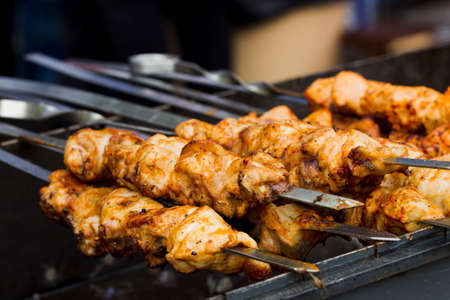 Shish kebab on skewers on the grill with hot coals, natural lightの写真素材