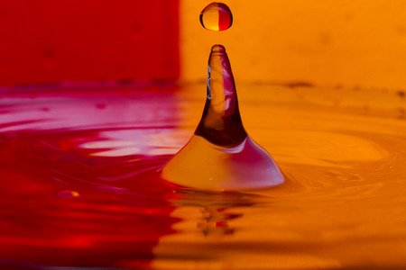 Bursts, spray, falling water drops on a color background, studio lighting, Macroの写真素材