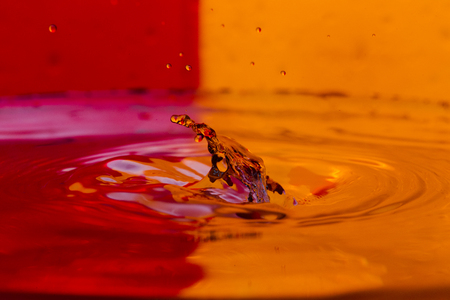 Bursts, spray, falling water drops on a color background, studio lighting, Macroの写真素材